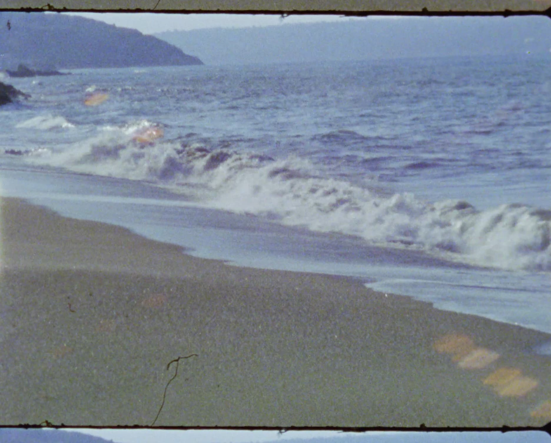 Waves running up a beach, on Super 8 film